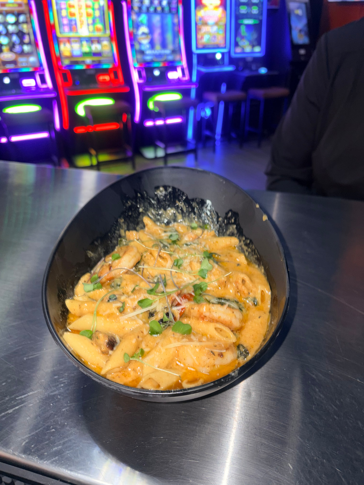 Jenn's O91 three-meat Cajun alfredo penne in a black bowl