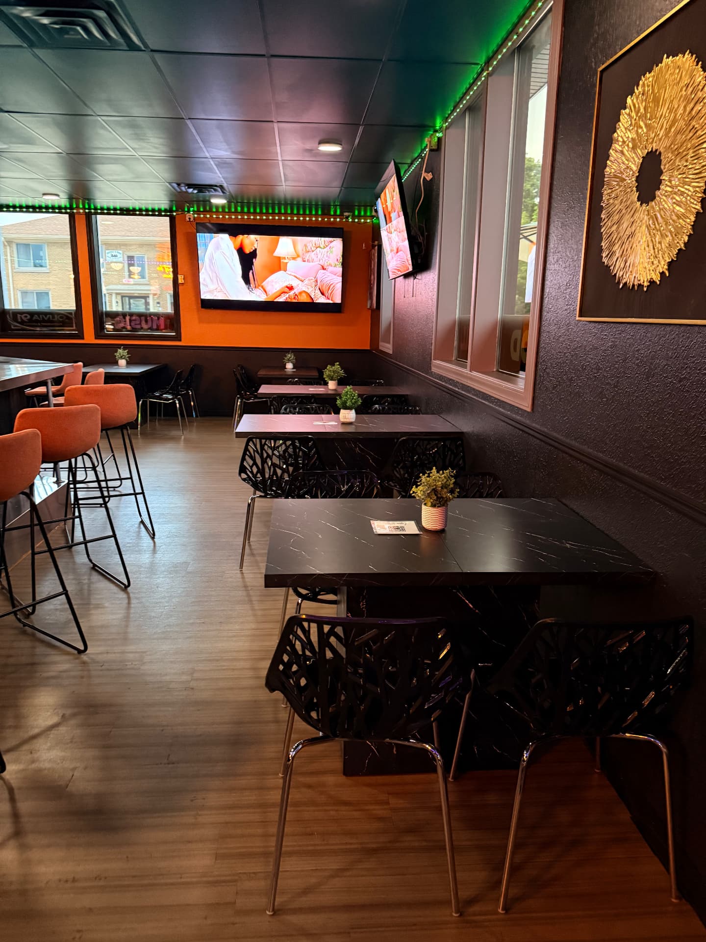 Dining room seating with televisions at Olivia 91