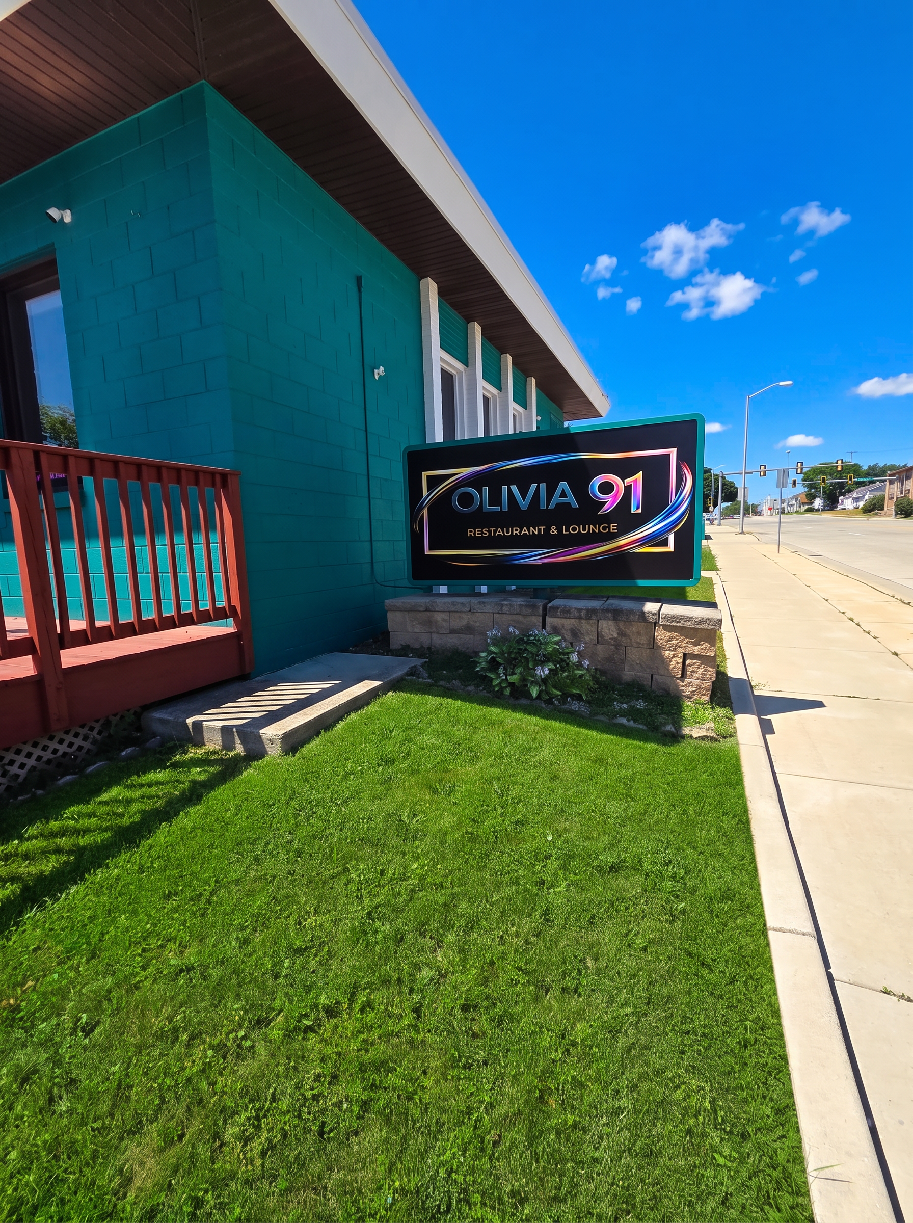 Exterior of the teal Olivia 91 building in West Allis, Wisconsin