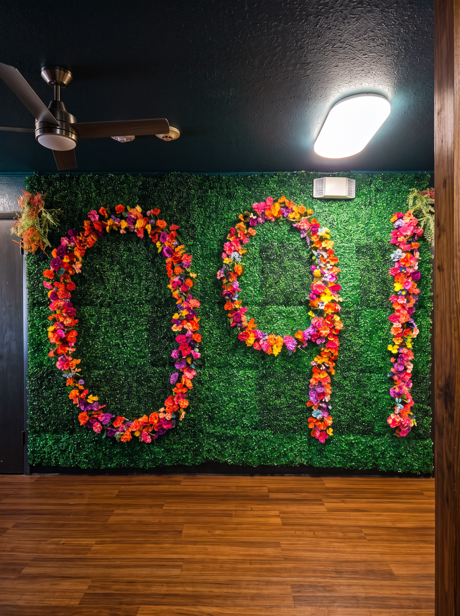 Floral 091 letter wall on a green hedge backdrop inside Olivia 91